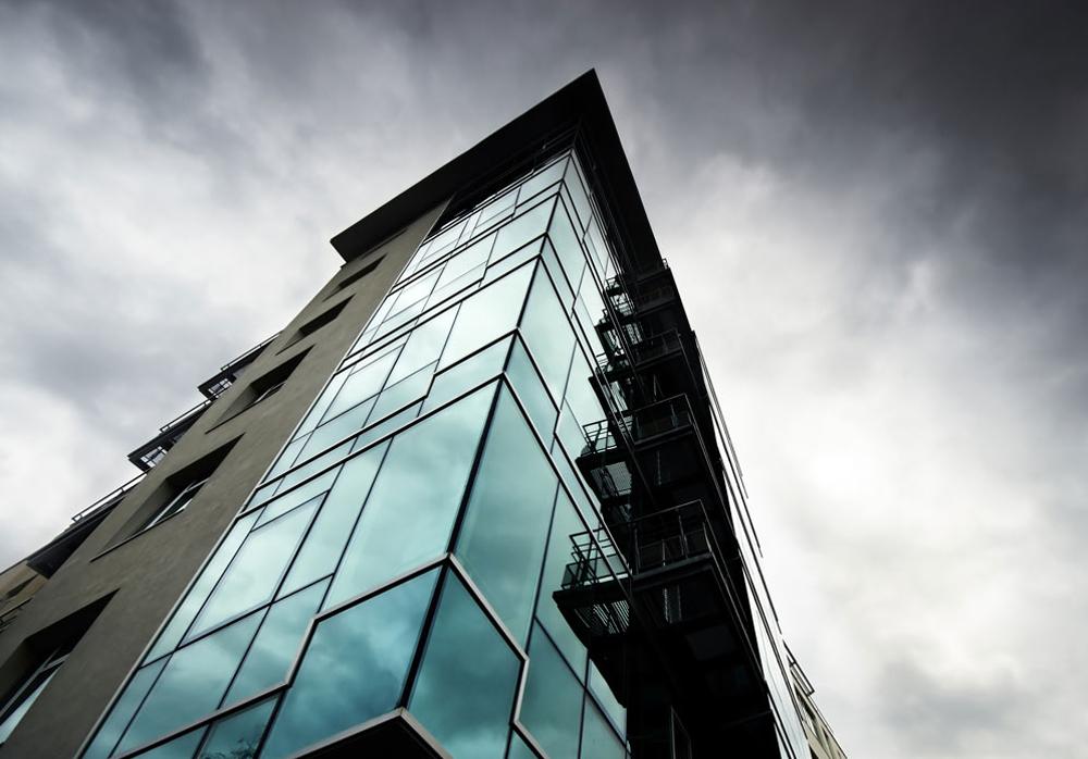 Glass-fronted commercial office building seen from street level